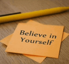 a sticky note that says " believe in yourself " next to a yellow pen