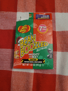 a package of bean boozled jelly beans sits on a red and white checkered cloth