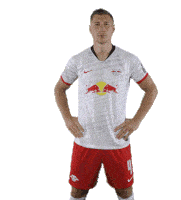 a soccer player wearing a white jersey with red bulls on it