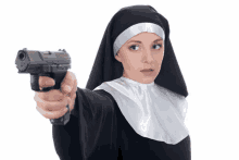 a nun holds a gun in her right hand