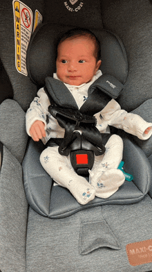 a baby is sitting in a car seat that says maxi cosi