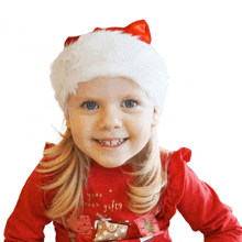 a little girl wearing a santa hat and a red shirt that says " from your dream gift "