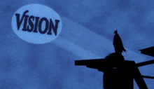 a silhouette of a batman stands in front of a projection of the word vision