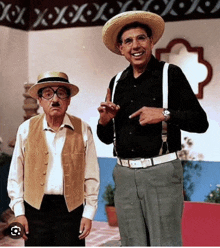 two men wearing straw hats and suspenders are standing next to each other and smiling