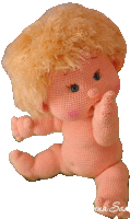 a knitted baby doll with blonde hair is sitting on a white background