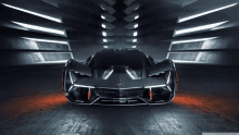 a black lamborghini is sitting in a dark room