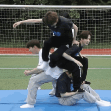 a group of young men are playing a game on a field and one of them is wearing a t-shirt that says alexander