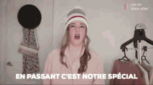 a woman wearing a hat says en passant c'est notre special in a video