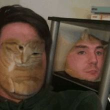 a man with a cat on his face is sitting next to another man with a cat on his face .