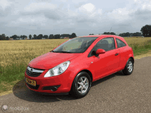 a red car with a license plate that says tsgn-71