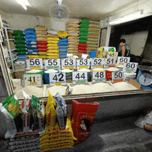 several bags of rice are lined up on a shelf with numbers on them