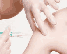 a close up of a person getting an injection in their arm .