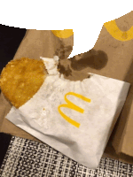 a mcdonald 's bag with a fried food on it