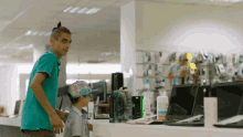 a man in a green shirt stands next to a boy wearing a hat that says ' rainbow ' on it