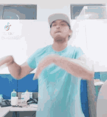 a man in a blue shirt and hat is dancing