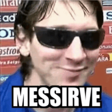 a man wearing sunglasses and a blue shirt is making a funny face with the words messirve written on it .