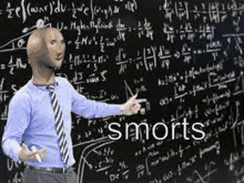 a man with a bald head is standing in front of a blackboard with math equations .