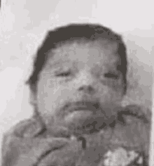 a black and white photo of a newborn baby .