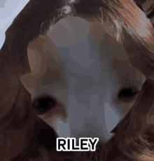 a close up of a person 's face with the name riley on it