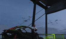 a man sits on the back of a green kawasaki buggy