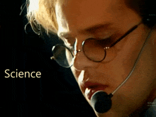 a close up of a person wearing glasses and a microphone with the word science on the bottom