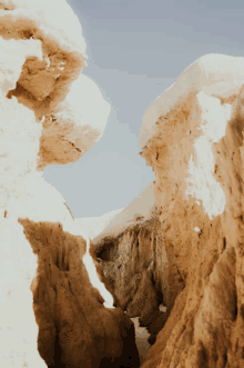 a canyon in the desert with a blue sky behind it