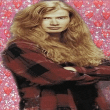 a man with long hair is standing with his arms crossed in front of a pink background with hearts and stars