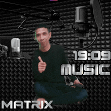 a man giving a thumbs up in front of a microphone with the words matrix music