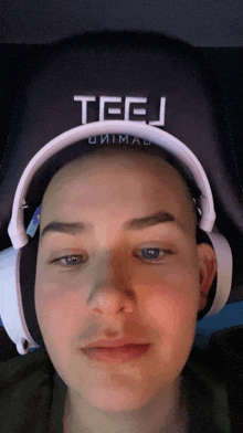 a person wearing headphones with the word teej on the back