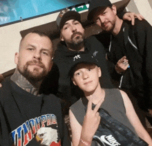 a man wearing a t-shirt that says liberty pride poses with two other men