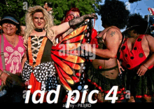 a group of people are posing for a picture and one of them is dressed as a butterfly