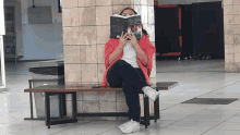 a woman is sitting on a bench reading a book called ' a brief history of time '