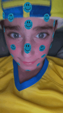 a boy with smiley faces on his face