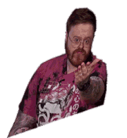 a man with a beard and glasses is wearing a pink shirt and making a hand gesture .