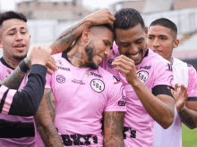 a group of soccer players wearing pink shirts with sba on the front