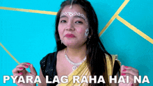 a woman wearing a necklace and a saree says pyara lag raha haina