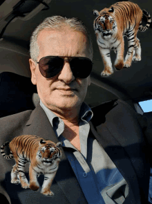 a man wearing sunglasses has three tigers on his shirt