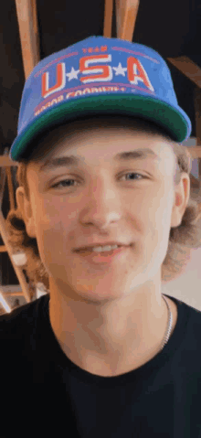 a young man wearing a hat that says usa