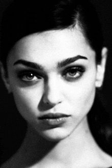 a black and white photo of a woman 's face with a serious look on her face