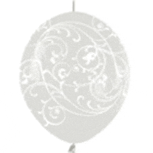 a white balloon with a white swirl pattern on it is hanging from a string .