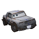 a rusty car from the movie cars is sitting on a white surface .