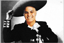 a black and white photo of a man wearing a sombrero and smiling