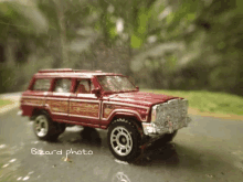 a red toy jeep with the word bizarre photo written on the bottom