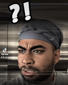 a man with a bandana on his head has a question mark on his face