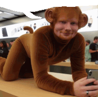 a man dressed in a monkey costume holds a cell phone