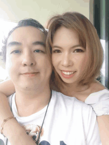 a man and a woman are posing for a picture and the woman is wearing a shirt that says ' snoopy '