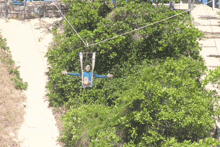 a person is flying through the air on a ropes course