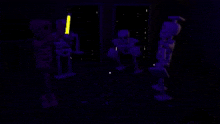 a group of skeletons are glowing in the dark in a room .