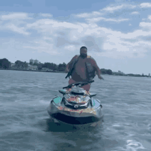 a man is riding a jet ski through the water .