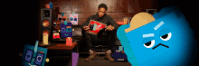 a man sitting on a couch holding a record next to a blue monster